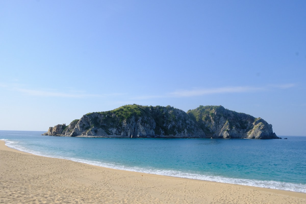 Sandy beach next to a large body of water on the Oaxacan coast