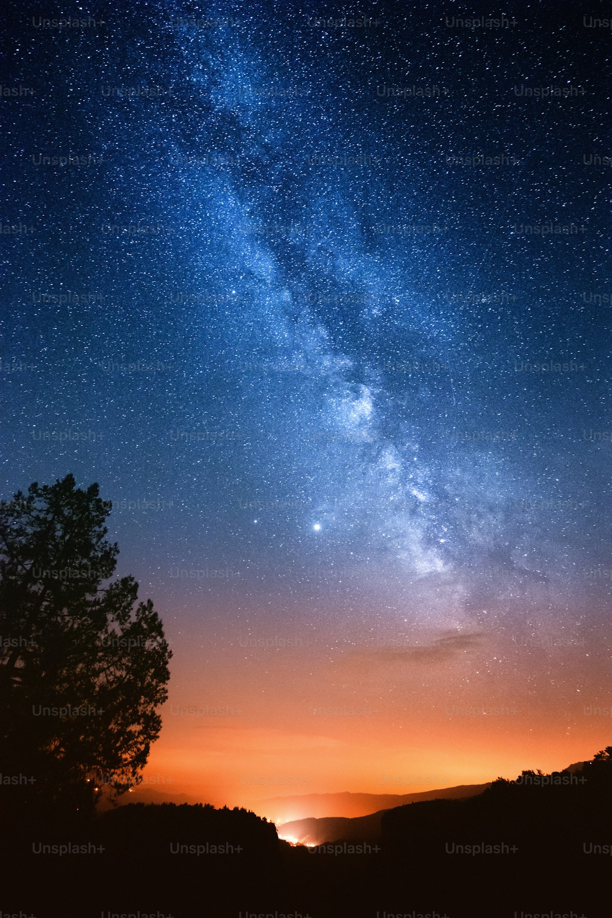 Milky Way reflected over a distant landscape