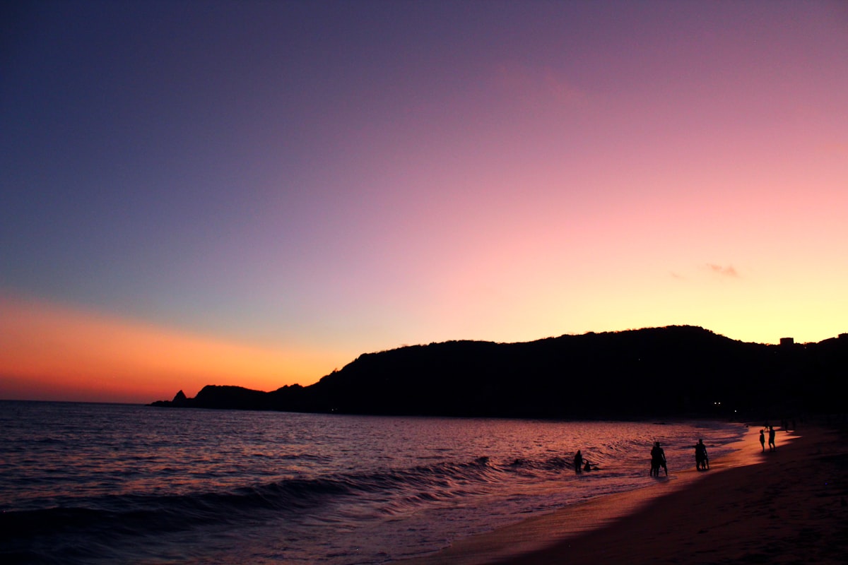Silhouette of people on the beach at sunset