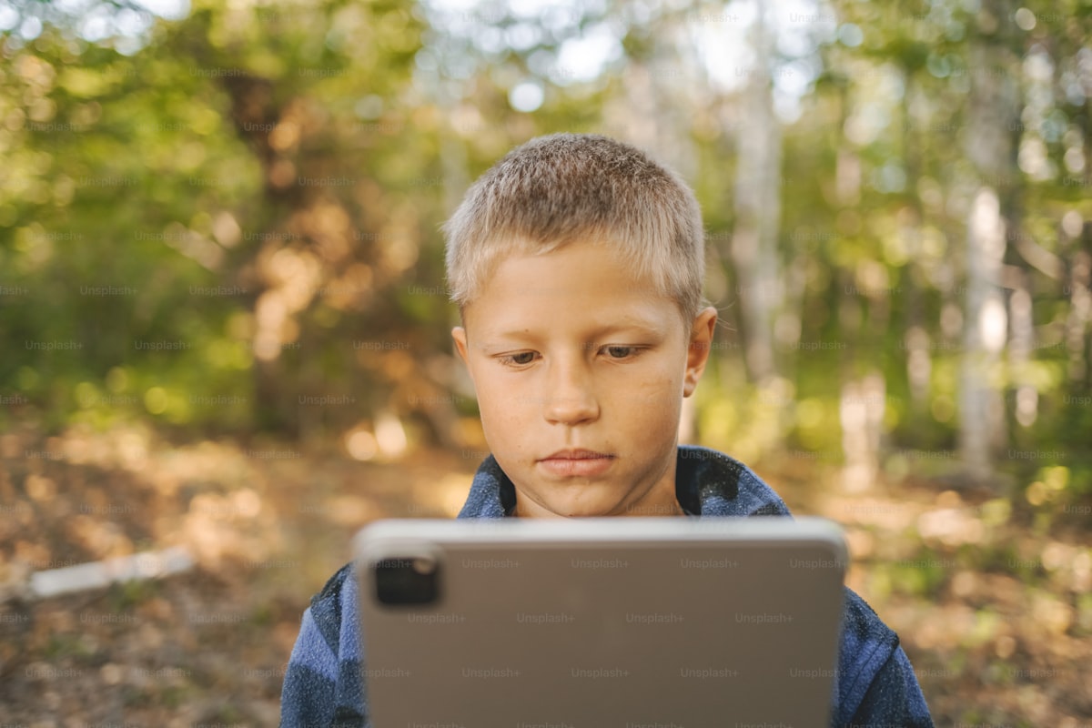 Young student learning outdoors in a woodland setting