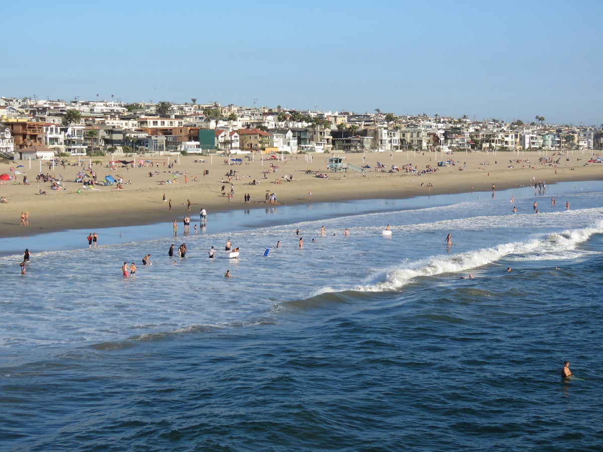 People enjoying the waves on a sunny beach day