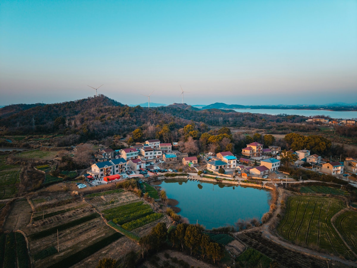 Aerial view of a village by a lagoon at sunset