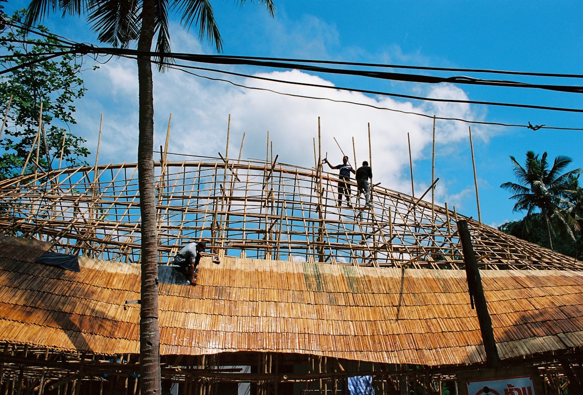 Community members working together on a rooftop construction project