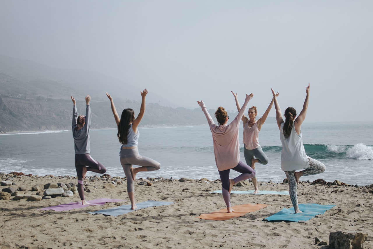 Yoga practice at sunrise on a tropical beach, morning light over the Pacific Ocean